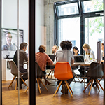 Business people video conferencing in office - GettyImages-867417022