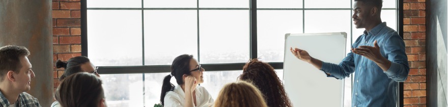 African-american leader lecturing his employees in office stock