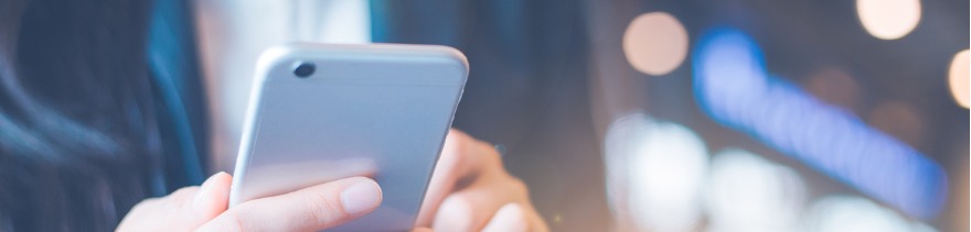 Business women hand using cell phone in office