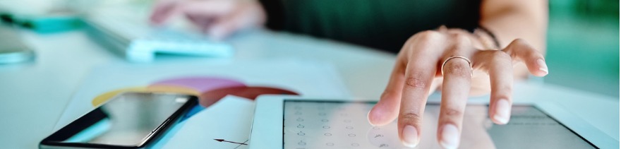 Businesswoman Using a Digital Tablet at Her Desk