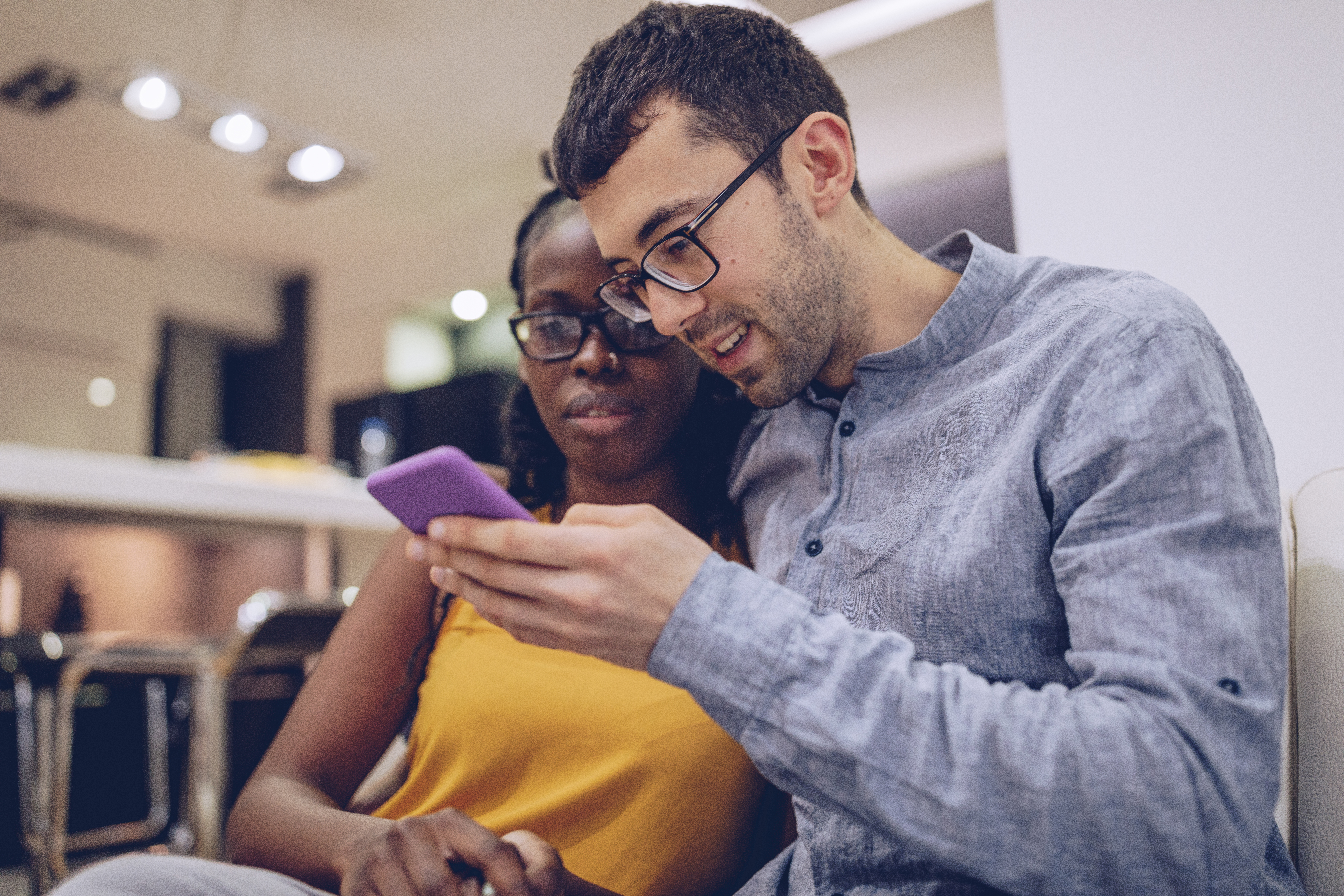 A man and a woman looking at a phone